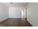 Living room with wood-look floors, neutral walls and open access to the kitchen at 15725 W Lundberg St, Surprise, AZ 85374