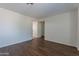 Light-filled living room with wood-look floors and neutral walls at 15725 W Lundberg St, Surprise, AZ 85374