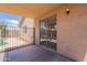 Covered patio area with privacy fencing and a glimpse of the refreshing pool area at 15725 W Lundberg St, Surprise, AZ 85374