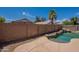 Beautiful backyard pool with mature landscaping offering a private and serene setting at 15725 W Lundberg St, Surprise, AZ 85374