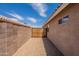 The side yard features a secure gate, gravel ground covering, and a block wall offering privacy and security at 15725 W Lundberg St, Surprise, AZ 85374