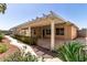 This home has a large covered back patio and manicured landscaping at 1625 E Daisy St, Casa Grande, AZ 85122