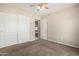 Bedroom featuring a ceiling fan and closet with sliding doors at 1625 E Daisy St, Casa Grande, AZ 85122
