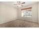 Bedroom with ceiling fan and sunny window with view to the back yard at 1625 E Daisy St, Casa Grande, AZ 85122