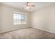 Cozy bedroom featuring a ceiling fan and bright window views at 1625 E Daisy St, Casa Grande, AZ 85122