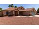 Inviting single-story home featuring desert landscaping, a tile roof, and an attached two-car garage at 1625 E Daisy St, Casa Grande, AZ 85122