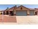 Charming single-story home featuring a three-car garage, desert landscaping, and a tile roof at 1625 E Daisy St, Casa Grande, AZ 85122