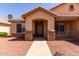 Charming single-story home featuring a welcoming front entrance with decorative stone accents and desert landscaping at 1625 E Daisy St, Casa Grande, AZ 85122