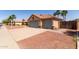 Exterior shot of a three-car garage with desert landscaping and mature palm trees in the background at 1625 E Daisy St, Casa Grande, AZ 85122
