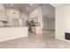 Well-lit kitchen featuring tile floors, granite countertops, stainless steel appliances, and a breakfast bar at 1625 E Daisy St, Casa Grande, AZ 85122