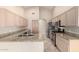Gourmet kitchen boasts granite counters, stainless appliances, ample cabinet space, and tile flooring at 1625 E Daisy St, Casa Grande, AZ 85122