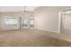 Spacious living room featuring plush carpet, neutral paint, and access to the backyard patio at 1625 E Daisy St, Casa Grande, AZ 85122