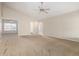 Open-concept living area with plush carpet, neutral paint, and a view into adjacent rooms at 1625 E Daisy St, Casa Grande, AZ 85122