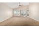 Spacious living room features neutral decor, ceiling fan, and natural light from large windows at 1625 E Daisy St, Casa Grande, AZ 85122