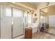 A relaxing bathroom features a walk-in shower and a soaking tub next to a decorative window at 16337 W Pierce St, Goodyear, AZ 85338