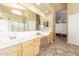 A spacious bathroom features double sinks, a vanity, and a large mirror with great natural light at 16337 W Pierce St, Goodyear, AZ 85338