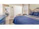 A stylish bedroom with an iron bed frame, soft chair, and a large window with natural light at 16337 W Pierce St, Goodyear, AZ 85338