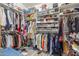 This walk-in closet has ample storage space with shelves and racks for organizing clothes and shoes at 16337 W Pierce St, Goodyear, AZ 85338