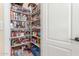 Pantry with stocked shelving and a white door at 16337 W Pierce St, Goodyear, AZ 85338