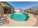 Backyard featuring a private pool, covered patio, and a rock waterfall feature at 16337 W Pierce St, Goodyear, AZ 85338