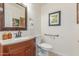 This half bathroom has an undermount sink with a granite countertop and a comfort-height toilet at 16337 W Pierce St, Goodyear, AZ 85338