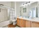 Well lit bathroom with double sink vanity, shower and bath at 16398 N Oachs Dr, Surprise, AZ 85374