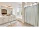 Bathroom featuring a double sink vanity, separate shower and bathtub, and a large window at 16398 N Oachs Dr, Surprise, AZ 85374