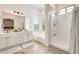 Bright bathroom featuring a double sink vanity, separate shower and bathtub, and a large window at 16398 N Oachs Dr, Surprise, AZ 85374