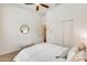 Bedroom featuring a ceiling fan, large closet, and decorative mirror at 16398 N Oachs Dr, Surprise, AZ 85374