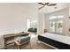 Bright bedroom features a work space with a desk, chair, and ceiling fan at 16398 N Oachs Dr, Surprise, AZ 85374