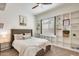 Bedroom features a bed, shelving, a window and neutral colored walls at 16398 N Oachs Dr, Surprise, AZ 85374