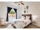 This bedroom features a queen bed, curtains and stylish wall decor at 16398 N Oachs Dr, Surprise, AZ 85374