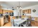 A spacious dining area with wood floors adjacent to kitchen at 16398 N Oachs Dr, Surprise, AZ 85374
