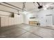 Spacious garage featuring ample storage cabinets, utility sink, and epoxy flooring at 16398 N Oachs Dr, Surprise, AZ 85374