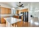 Well-equipped kitchen with modern appliances, wood cabinets, and a functional center island at 16398 N Oachs Dr, Surprise, AZ 85374