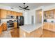 Bright kitchen features wood cabinets, stainless steel appliances, and an island at 16398 N Oachs Dr, Surprise, AZ 85374