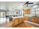 Modern kitchen with a center island, stainless steel appliances, and open layout to dining and living areas at 16398 N Oachs Dr, Surprise, AZ 85374
