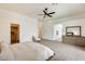 Spacious main bedroom boasting plush carpet, a ceiling fan, and an en-suite bathroom with a large dresser at 16398 N Oachs Dr, Surprise, AZ 85374