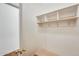 Functional mud room with a built-in bench, coat hooks, and storage shelves for organization at 16398 N Oachs Dr, Surprise, AZ 85374
