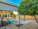 Inviting backyard pool with covered patio, mature orange tree and ample seating area at 16398 N Oachs Dr, Surprise, AZ 85374