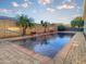 The beautiful in-ground backyard pool features brick trim and custom water features at 16398 N Oachs Dr, Surprise, AZ 85374