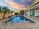 The serene backyard pool features brick trim and custom water feature details at 16398 N Oachs Dr, Surprise, AZ 85374