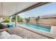Relaxing backyard showcasing a private pool, covered patio, and well-maintained landscaping at 16398 N Oachs Dr, Surprise, AZ 85374
