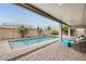 Backyard oasis with a refreshing private pool, covered patio, and serene ambiance at 16398 N Oachs Dr, Surprise, AZ 85374