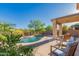 Backyard retreat with a shimmering pool and covered patio providing a serene and comfortable outdoor living space at 1721 E Cielo Grande Ave, Phoenix, AZ 85024