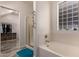 Bright bathroom features a soaking tub, glass-enclosed shower, and walk in closet access at 1721 E Cielo Grande Ave, Phoenix, AZ 85024