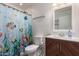 Bright bathroom featuring a vibrant shower curtain, modern vanity, and stylish decor at 1721 E Cielo Grande Ave, Phoenix, AZ 85024