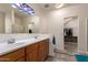 Spacious bathroom with double sinks, modern fixtures, and walk in closet access at 1721 E Cielo Grande Ave, Phoenix, AZ 85024