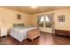 Bedroom features wood floors, large window, and neutral walls at 1721 E Cielo Grande Ave, Phoenix, AZ 85024