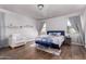 Inviting bedroom featuring wood floors, accent furniture, and natural light at 1721 E Cielo Grande Ave, Phoenix, AZ 85024